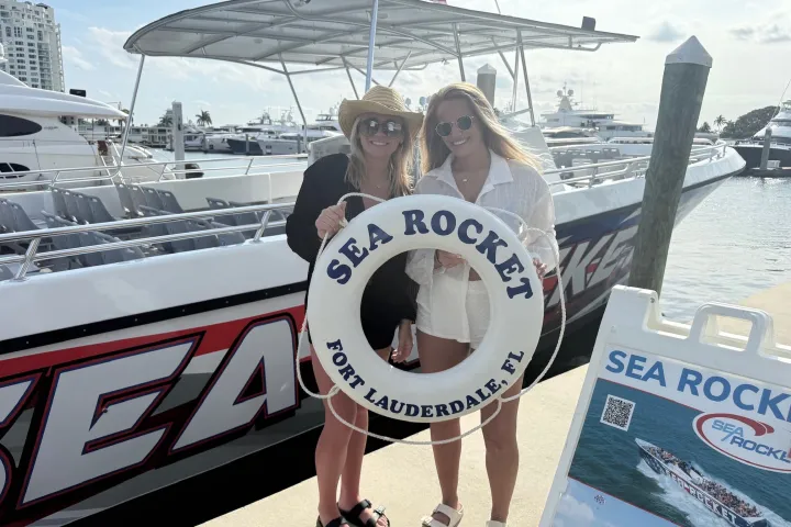 a person holding a sign posing for the camera