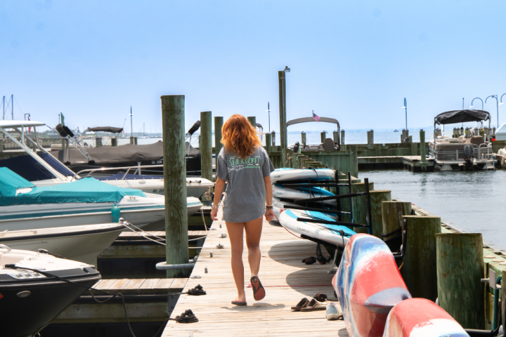 a woman walking down the dock
