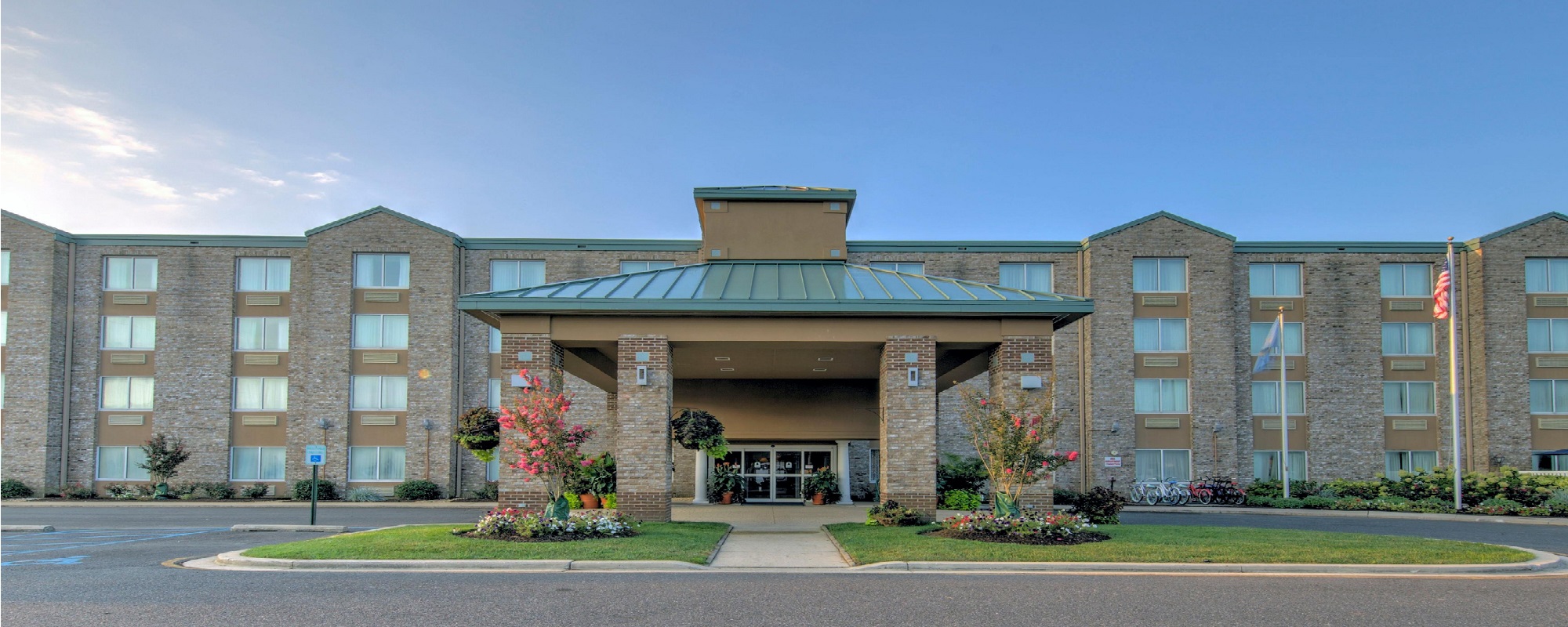 an empty parking lot in front of a brick building