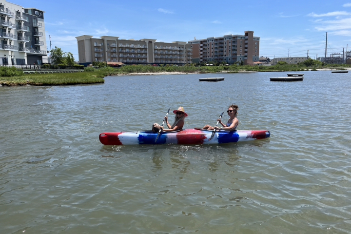 a group of people in a small boat in a body of water