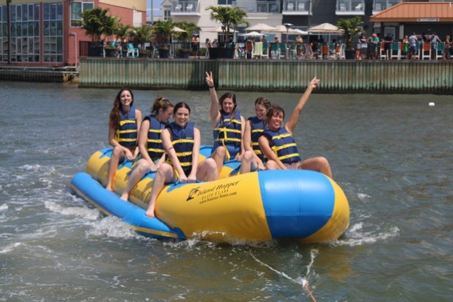 a group of people riding on a raft in a body of water