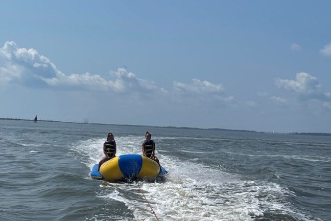 a man standing next to a body of water