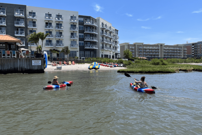 a group of people in a small boat in a body of water