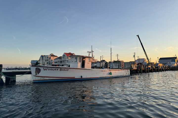 a boat is docked next to a body of water