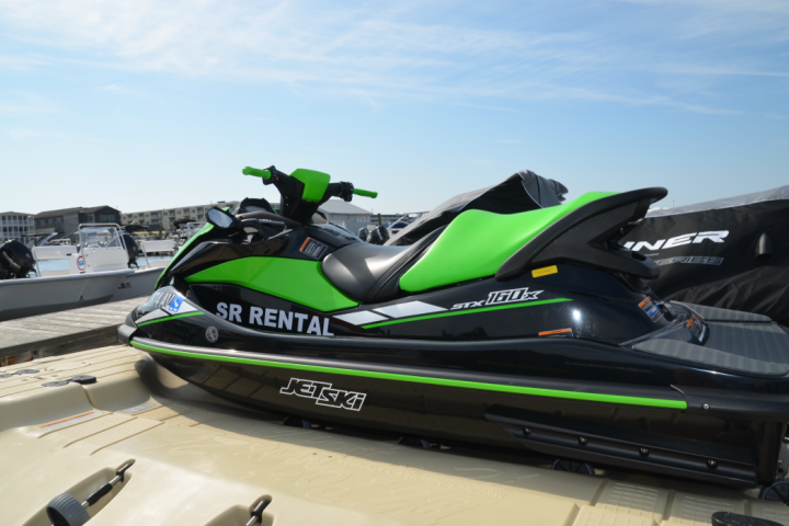 a green motorcycle parked on the side of a road