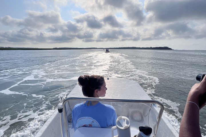 a man standing next to a body of water