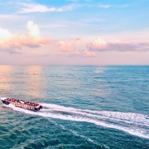 a body of water with smoke coming out of the ocean