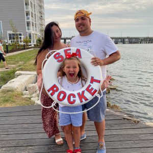 a man and a woman standing next to a body of water