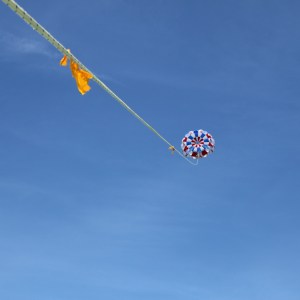 a person flying a kite in a clear blue sky