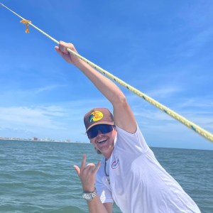 a man standing next to a body of water