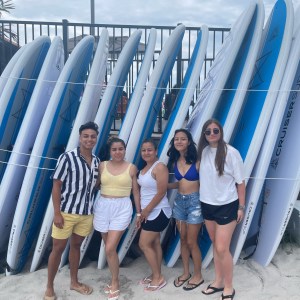 a group of people standing next to a fence