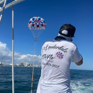 a man standing next to a body of water