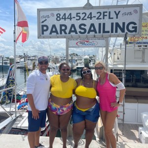 a group of people holding a sign posing for the camera