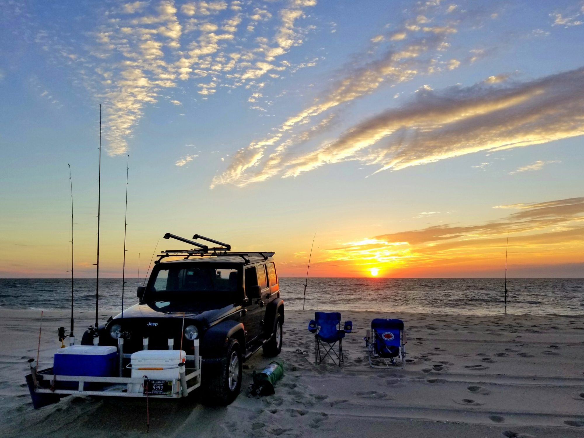 Dewey Beach, Delaware, U.S – September 5, 2020 – A black Jeep eq a group of people on a beach