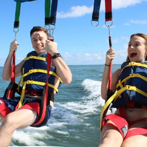 a group of people standing next to a body of water