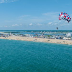 a group of people on a beach near a body of water
