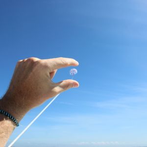 a person flying through the air on a clear blue sky