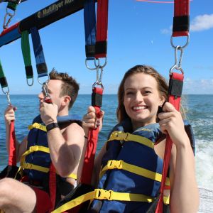 a couple of people that are standing in a body of water