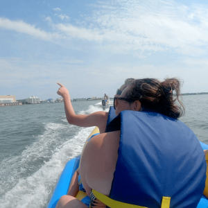 a man and a woman standing next to a body of water