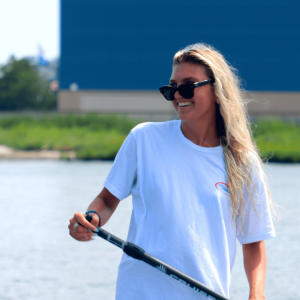 a man standing next to a body of water