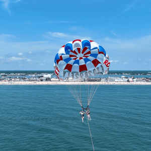 a person flying a kite in a large body of water