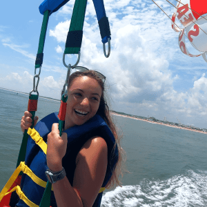 a person holding a kite in a boat on a body of water