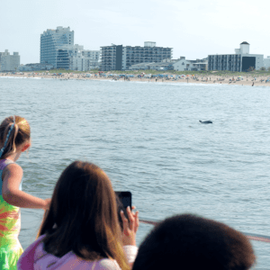 a man and a woman standing in front of a body of water