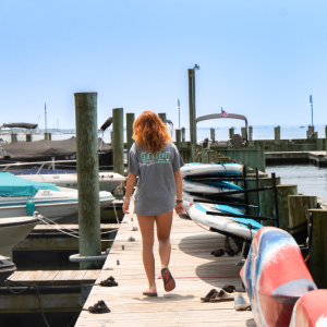a woman sitting at a dock