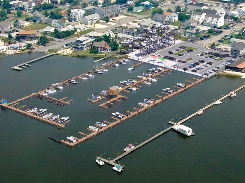 dewey beach yacht club a large body of water with a city in the background