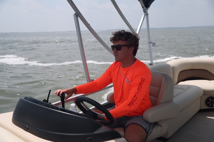 a man sitting in a boat on a body of water