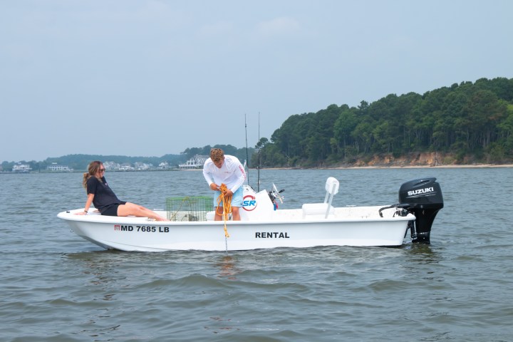 a person riding on the back of a boat in the water