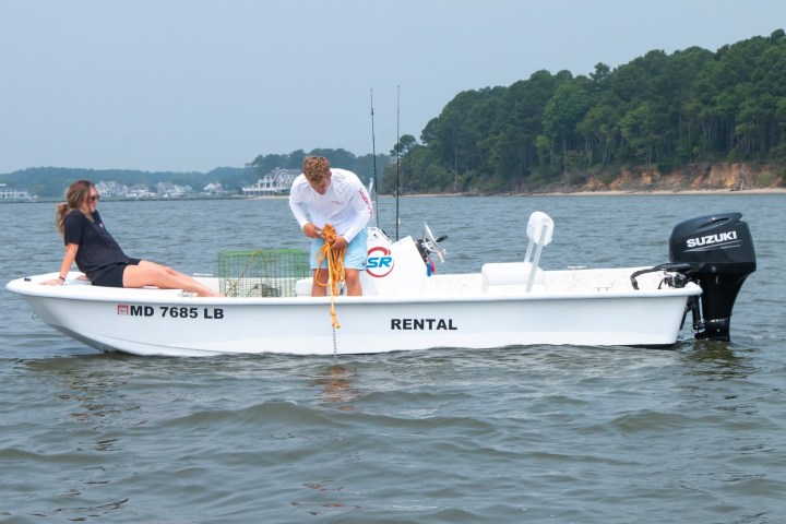 a person riding on the back of a boat in a body of water