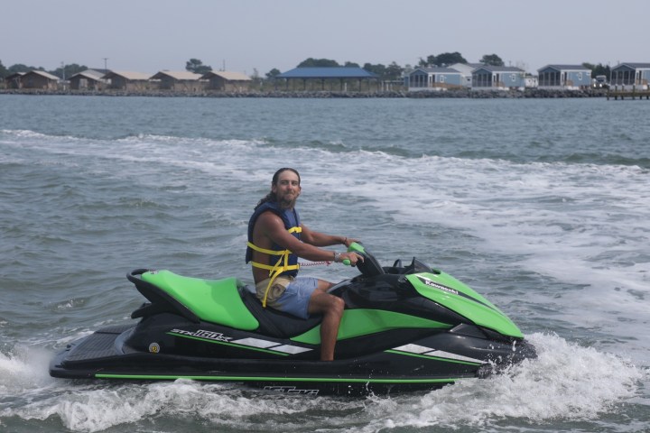 a man riding a wave on a surf board on a body of water