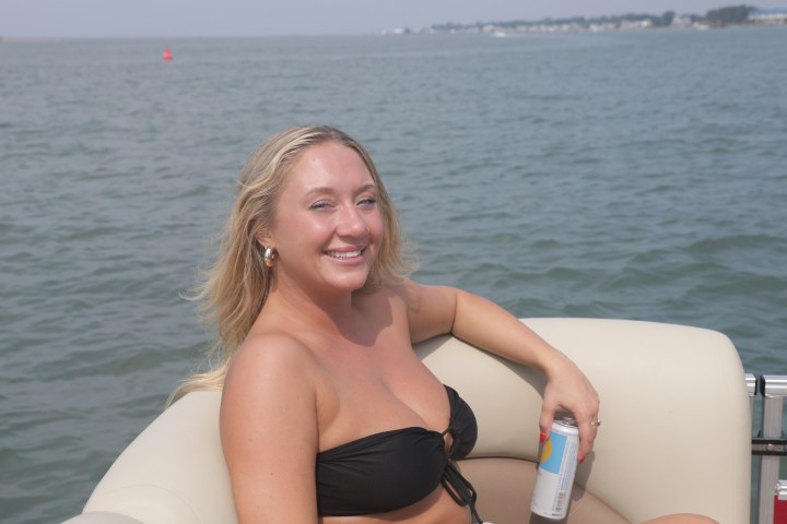 a woman standing next to a body of water