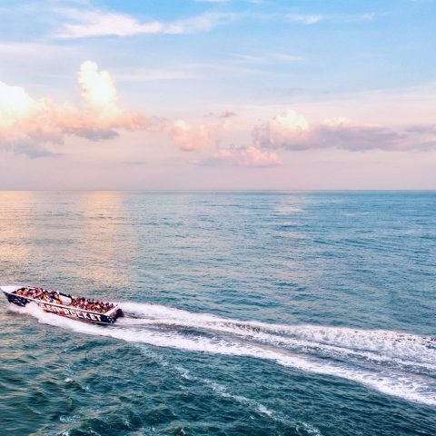 a body of water with smoke coming out of the ocean