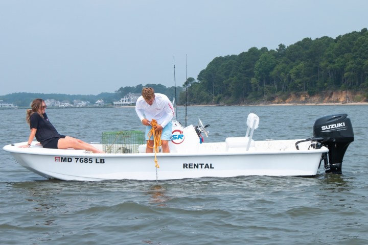 a person riding on the back of a boat in the water