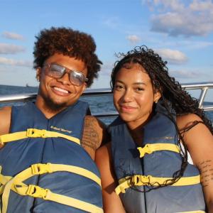 a man and a woman standing next to a body of water