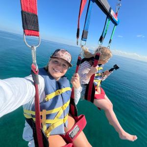 a person holding a kite in a boat on a body of water