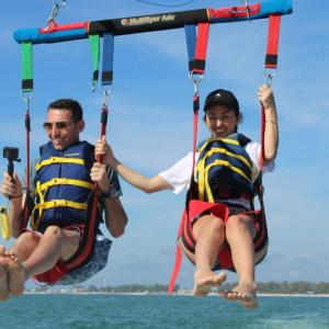 a group of people riding on the back of a boat in the water