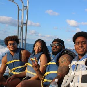 a group of people on a boat posing for the camera