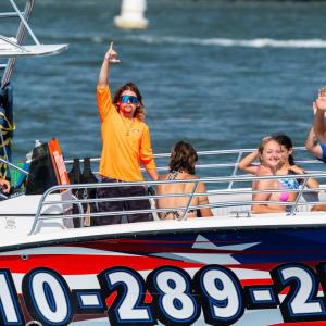 a group of people riding on the back of a boat