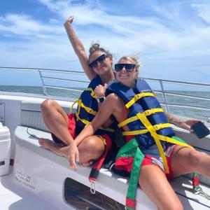 a woman riding on the back of a boat