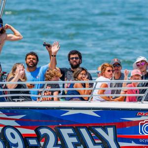 a group of people riding on the back of a boat