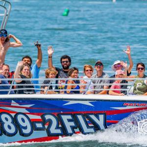 a group of people riding on the back of a boat