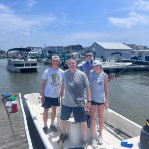 a group of people standing next to a body of water