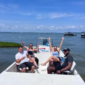 a group of people sitting in a boat on a body of water
