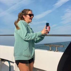 a person standing next to a body of water