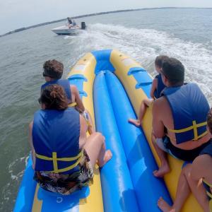 a group of people on a raft in a body of water