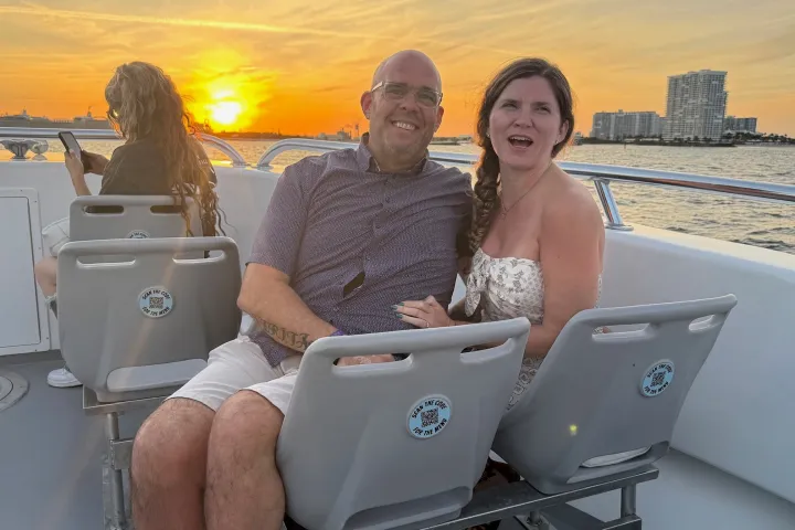 a man and a woman sitting at a beach