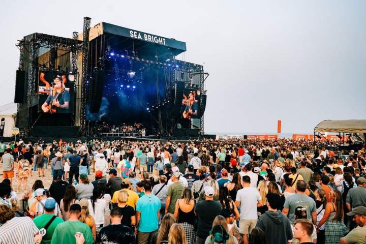 a group of people standing in front of a large crowd of people